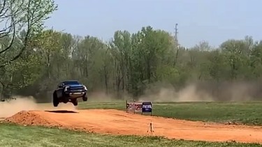 A screenshot of a Ford F-150 Raptor taking a 50-foot dirt jump