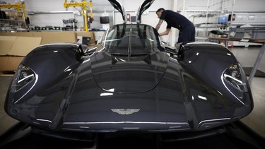 An employee works on the interior of an Aston Martin Valkyrie car at the company’s factory in Gaydon, Britain, March 16, 2022.