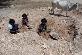 In this photograph taken on August 4, 2015, deaf Indian child labourer Nagina (C) and others collect mica at a scrap mine in Koderma district of the eastern Indian state of Jharkhand.