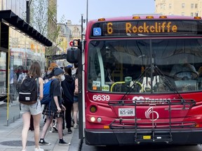 OTTAWA -- OC Transpo passengers board a bus on Rideau Street