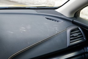 The gummy rubberized dash in the 2022 Subaru Crosstrek Outdoor holds dust and dirt