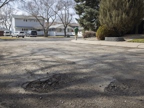 Broken pavement and potholes are shown on Mayfair Crescent on Monday, May 2, 2022 in Regina. Mayfair Crescent tops the CAA's list of worst roads in Saskatchewan (as voted on online).