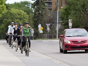 A group of cyclists heads down 83 Avenue near 106 Street on a bike ride hosted by the City of Edmonton's Bike Street Team on June 5, 2019, in Edmonton.