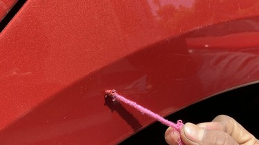 Touch up paint applied to a scratch