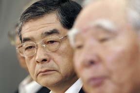 Suzuki Motor Corp. President Hiroshi Tsuda listens as Chairman and Chief Executive Osamu Suzuki speaks to reporters during a news conference in Tokyo August 9, 2006.