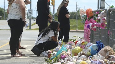 A group of women grieve at the crash scene memorial paying tribute for Karolina Ciasullo and her family Karla, 6; Lilianna, 3; and Mila, 1, who were killed  in a horrific crash  at Torbram Rd. and Countryside Dr. in Brampton, Ontario.