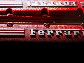 A closeup of the Ferrari logo on the valve cover of a V12 engine