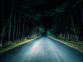 Headlights following a dark road