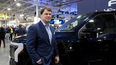 Ford CEO Jim Farley poses next to a model of the all-new Ford F-150 Lightning electric pickup truck at the Ford Rouge Electric Vehicle Center in Dearborn, Michigan, U.S. April 26, 2022.
