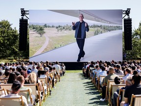 Apple CEO Tim Cook is displayed on a screen while speaking during Apple's annual Worldwide Developers Conference in San Jose, California, U.S. June 6, 2022.