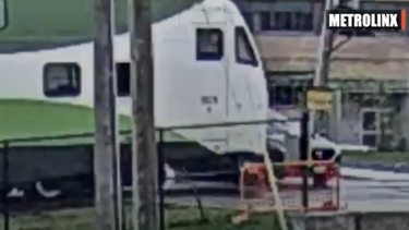 A screengrab from video released by Metrolinx of a car about to be hit by a GO Transit train after skirting the barrier.
