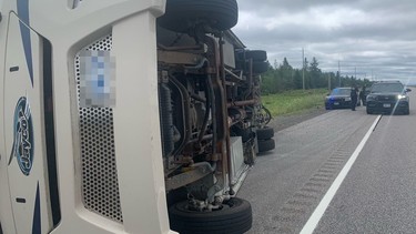 A recreational vehicle flipped on its side Thursday on Highway 69 at French River after striking a set of guardrails.