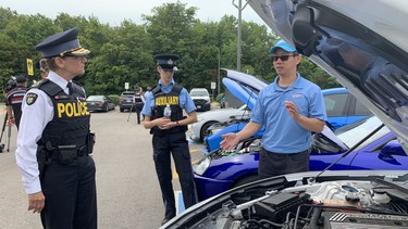 OPP Deputy Commissioner Rose DiMarco looks at a modified car during a news conference on Wednesday, July 27, 2022.