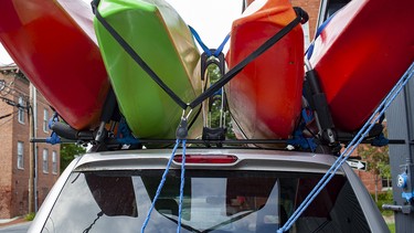 Four kayaks loaded on top of an SUV
