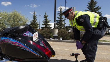 Const. Trevor Henderson of the Edmonton Police Service's traffic section tests the noise level of a motorcycle on May 28, 2020 in Edmonton. Motorcyclists with loud engines had the chance for their bikes to get tested during an amnesty event.