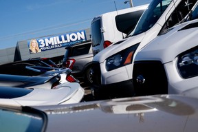 A banner reads ‘3 million vehicles sold and counting’ at a Ford car dealership in Falls Church, Virginia, on April 2, 2022.