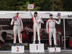 Valerie Limoges stands on the first-place position on the podium at the 2022 Nissan Sentra Cup