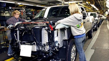 People work on a Chevy pickup truck on the assembly line of the General Motors Flint Assembly Plant January 24, 2011 in Flint, Michigan.