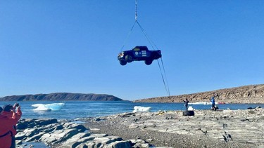 Transglobal Car Expedition's Ford F-150 being airlifted by helicopter