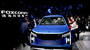 People take photos of Foxconn's new electric pickup vehicle, the Model V, during the company's annual Tech Day in Taipei, Taiwan, October 18, 2022