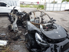 FILE - This image provided by the National Transportation Safety Board shows damage to a 2021 Tesla Model 3 Long Range Dual Motor electric car following a crash in September, 2021, in Coral Gables, Fla. A Florida jury on Tuesday, July 19, 2022, found electric car maker Tesla negligent for disabling a speed limiter on a vehicle but placed much of the blame for a fiery fatal crash on the 18-year-old driver. Barrett Riley and his friend Edgar Monserrat Martinez, both seniors at a private school in South florida, died in the May 2018 crash in Fort Lauderdale. A backseat passenger was ejected from the car and survived, officials said.
