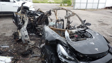 FILE - This image provided by the National Transportation Safety Board shows damage to a 2021 Tesla Model 3 Long Range Dual Motor electric car following a crash in September, 2021, in Coral Gables, Fla. A Florida jury on Tuesday, July 19, 2022, found electric car maker Tesla negligent for disabling a speed limiter on a vehicle but placed much of the blame for a fiery fatal crash on the 18-year-old driver. Barrett Riley and his friend Edgar Monserrat Martinez, both seniors at a private school in South florida, died in the May 2018 crash in Fort Lauderdale. A backseat passenger was ejected from the car and survived, officials said.