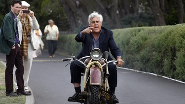 TV personality Jay Leno rides a 1930 Bohmerland motorcycle around the grounds during the Concours d'Elegance at the Pebble Beach Golf Links in Pebble Beach, California, August 17, 2014