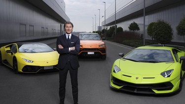 Lamborghini CEO Stephan Winkelmann posing with the company's model range