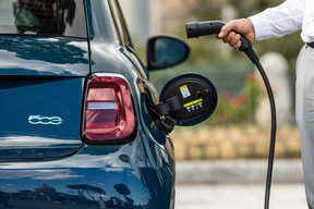 The European-spec Fiat 500e with an EV charging cable, about to be charged