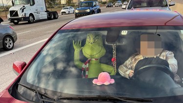 A Grinch blow-up doll in the passenger seat of a car spotted in the HOV lane of an Arizona highway
