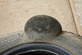 Delaminated tire bulging due to impact.