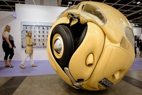 Visitors walk past the “Beetle Sphere” by Ichwan Noor at the Art Basel Hong Kong fair in Hong Kong on May 23, 2013