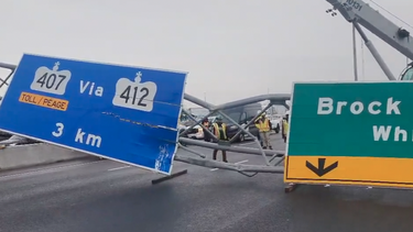 A screengrab from video posted by the OPP of a sign down on Highway 401 in Whitby after it was hit by a truck on Friday, Jan. 6, 2023.