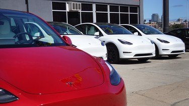 Tesla cars sit in a dealership lot on March 28, 2022 in Chicago, Illinois