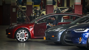 Tesla cars sit inside the service garage at a Tesla dealership in the Red Hook neighborhood in Brooklyn, August 7, 2018 in New York City