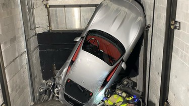 A Ferrari Roma in a Florida exotic-car dealership's elevator shaft