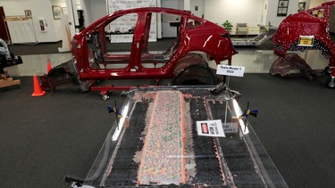 A partially disassembled 4680 structural battery pack from a 2022 Tesla Model Y, built in Austin, Texas, is displayed under a sheet of plexiglass in Auburn Hills, Michigan U.S. March 3, 2023