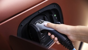 An EV charger being plugged into the port of a Jaguar Land Rover vehicle