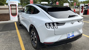 A Ford Mustang Mach-E at at Tesla charging station