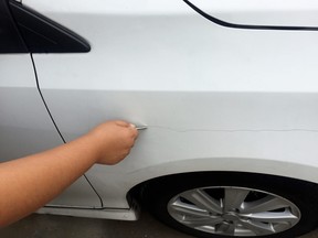 Vandal keying a car fender