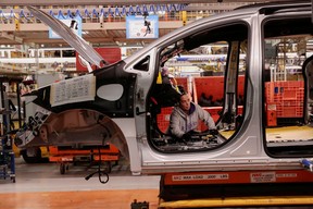 A Stellantis assembly worker works on the interior of a Chrysler Pacifica at the Windsor Assembly Plant in Windsor, Ontario, Canada, January 17, 2023