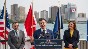U.S. Transportation Secretary Pete Buttigieg speaks while standing with Canadian Minister of Transport Omar Alghabra, left; and Michigan Governor Gretchen Whitmer during a press conference announcing the first Binational Electric Vehicle (EV) Corridor between the U.S. and Canada on Tuesday, May 16, 2023, along the Detroit River near the Detroit Port Authority Building