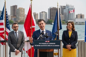 U.S. Transportation Secretary Pete Buttigieg speaks while standing with Canadian Minister of Transport Omar Alghabra, left; and Michigan Governor Gretchen Whitmer during a press conference announcing the first Binational Electric Vehicle (EV) Corridor between the U.S. and Canada on Tuesday, May 16, 2023, along the Detroit River near the Detroit Port Authority Building