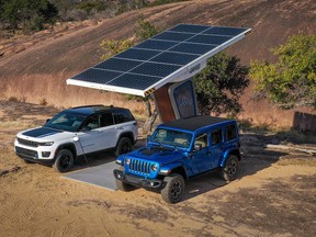 A 2023 Jeep Grand Cherokee Trailhawk 4xe and 2023 Jeep Wrangler Rubicon 4xe plugged into a remote charging station.