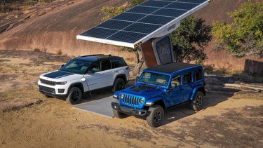 A 2023 Jeep Grand Cherokee Trailhawk 4xe and 2023 Jeep Wrangler Rubicon 4xe plugged into a remote charging station.