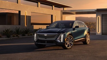 Front driver’s side 3/4 view of the 2024 Cadillac LYRIQ Luxury trim with front grille illuminated.