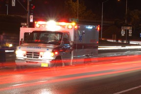 An ambulance in traffic at night