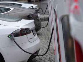 Tesla electric cars charge at a Tesla charging station on October 5, 2021 in Berlin, Germany