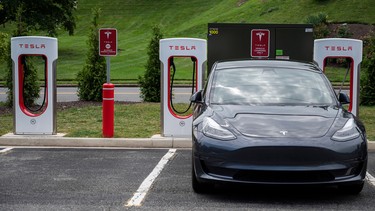 Cars charge at a Tesla super charging station in Arlington, Virginia on August 13, 2021