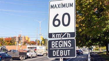 A 60-km/h speed limit sign on a road in Ottawa during rush hour